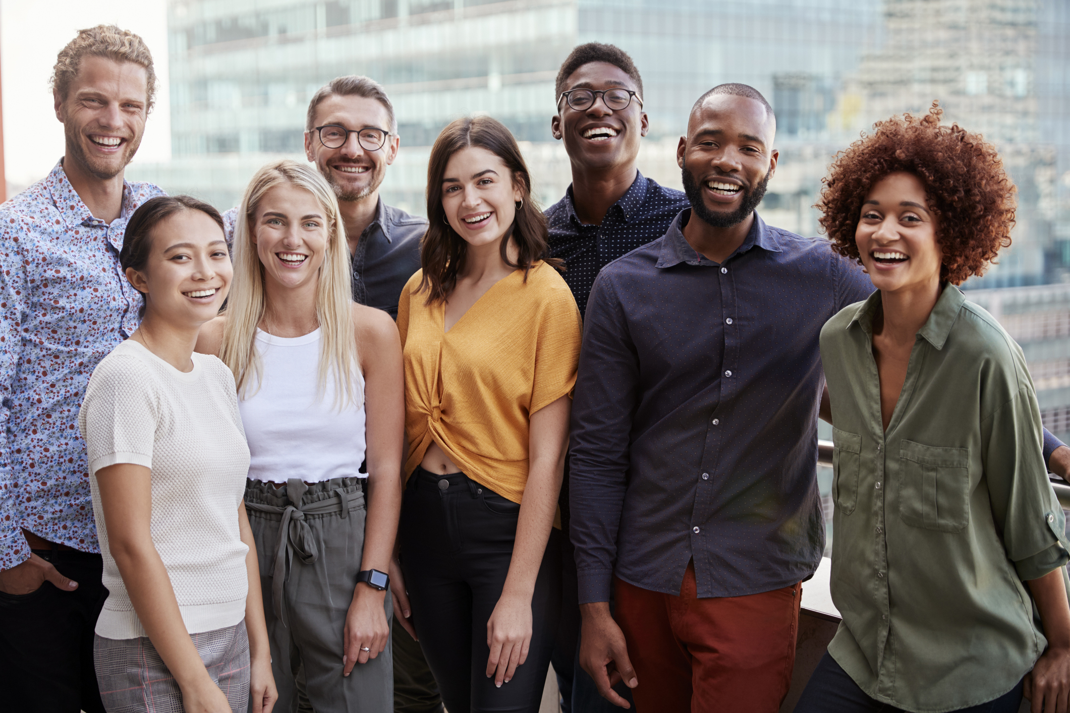 8 People standing in front of the camera smiling