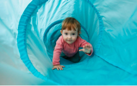 child climbing through tunnel